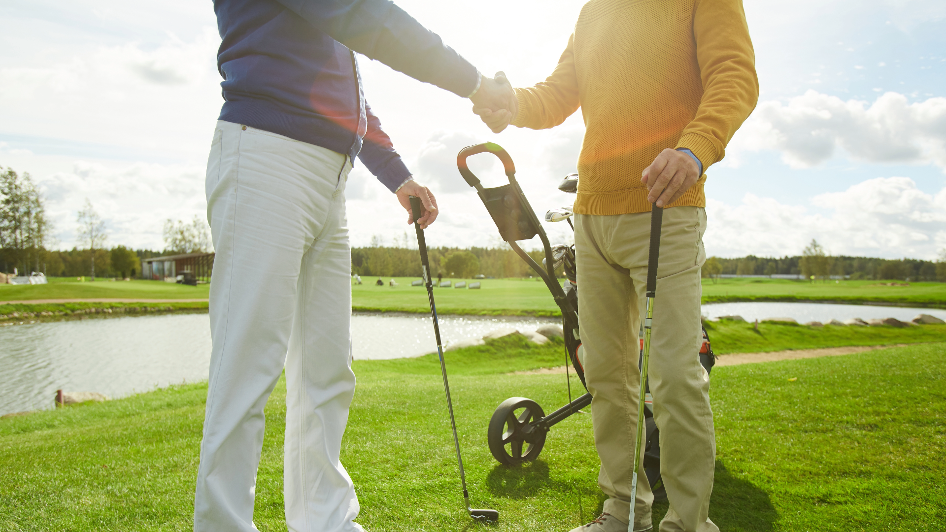 Two golfers shaking hands on the golf course