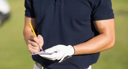 Golfer keeping score on a scorecard
