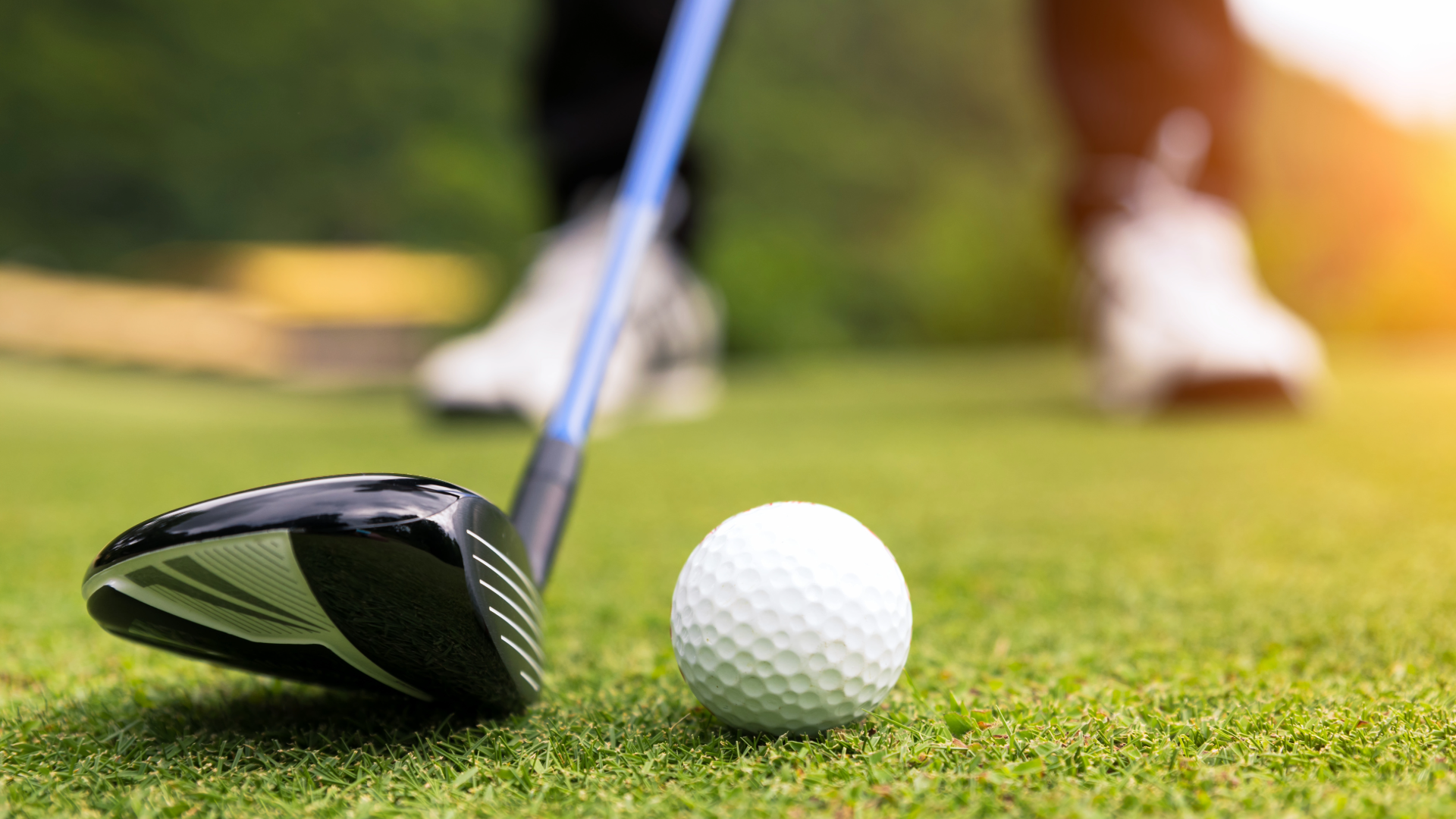 Close up of a golfer teeing up, blurred out foot placement in the background
