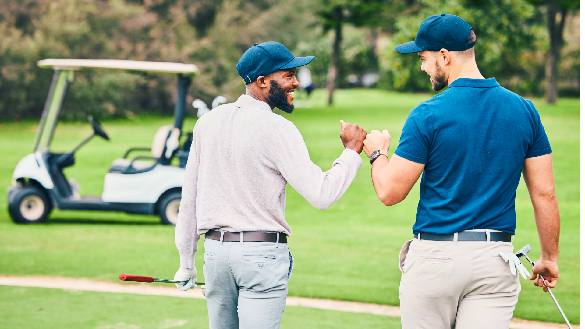 Two golfers fist bumping