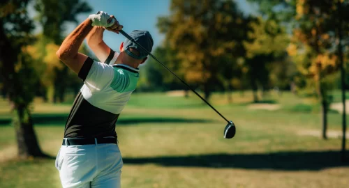 Golfer with club behind his back after a swing