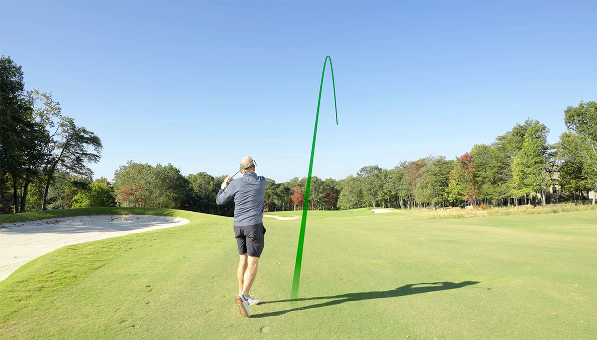 Older golfer hitting a straight shot.