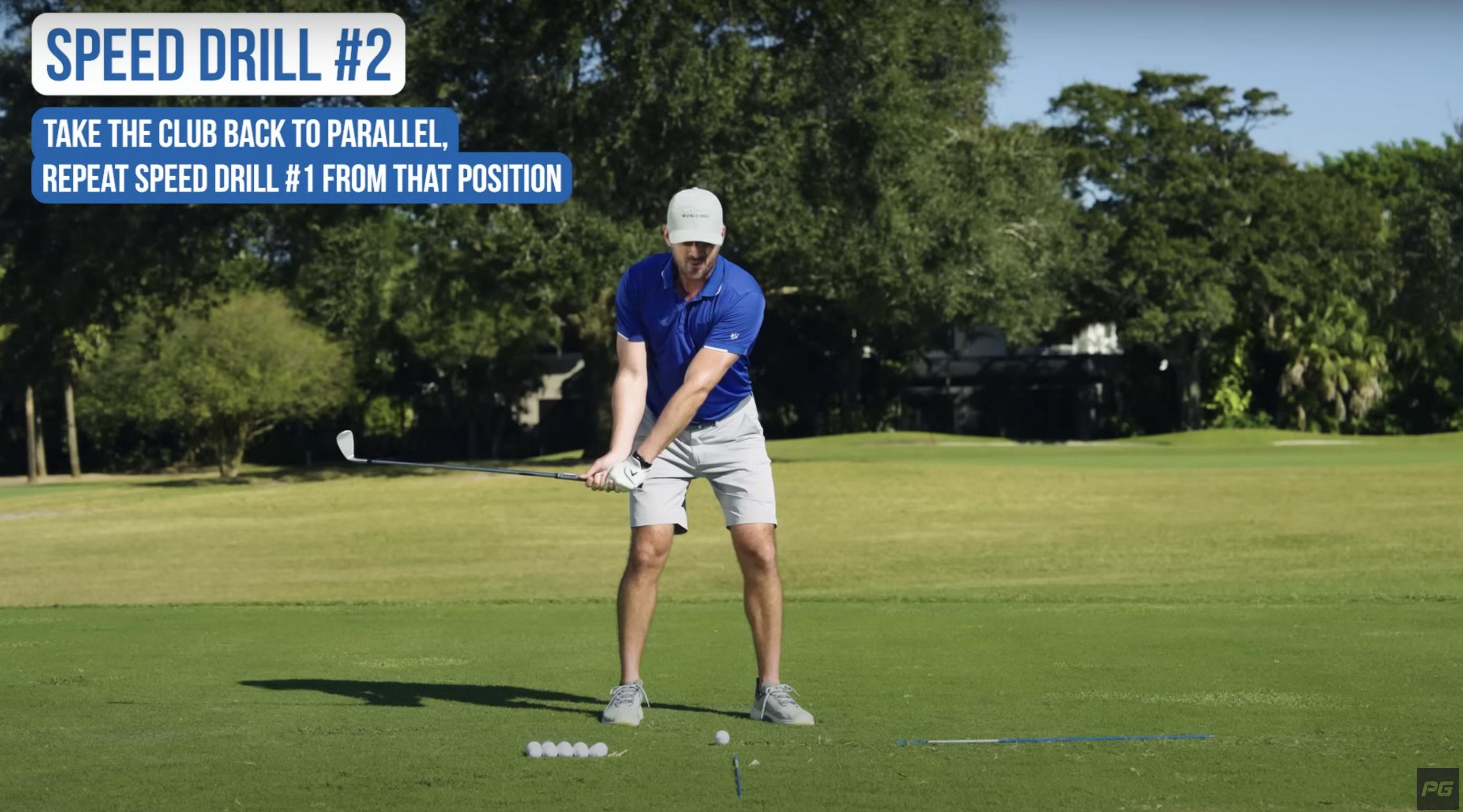 Performance Golf coach holding a golf club parallel to the ground demonstrating a golf swing drill.