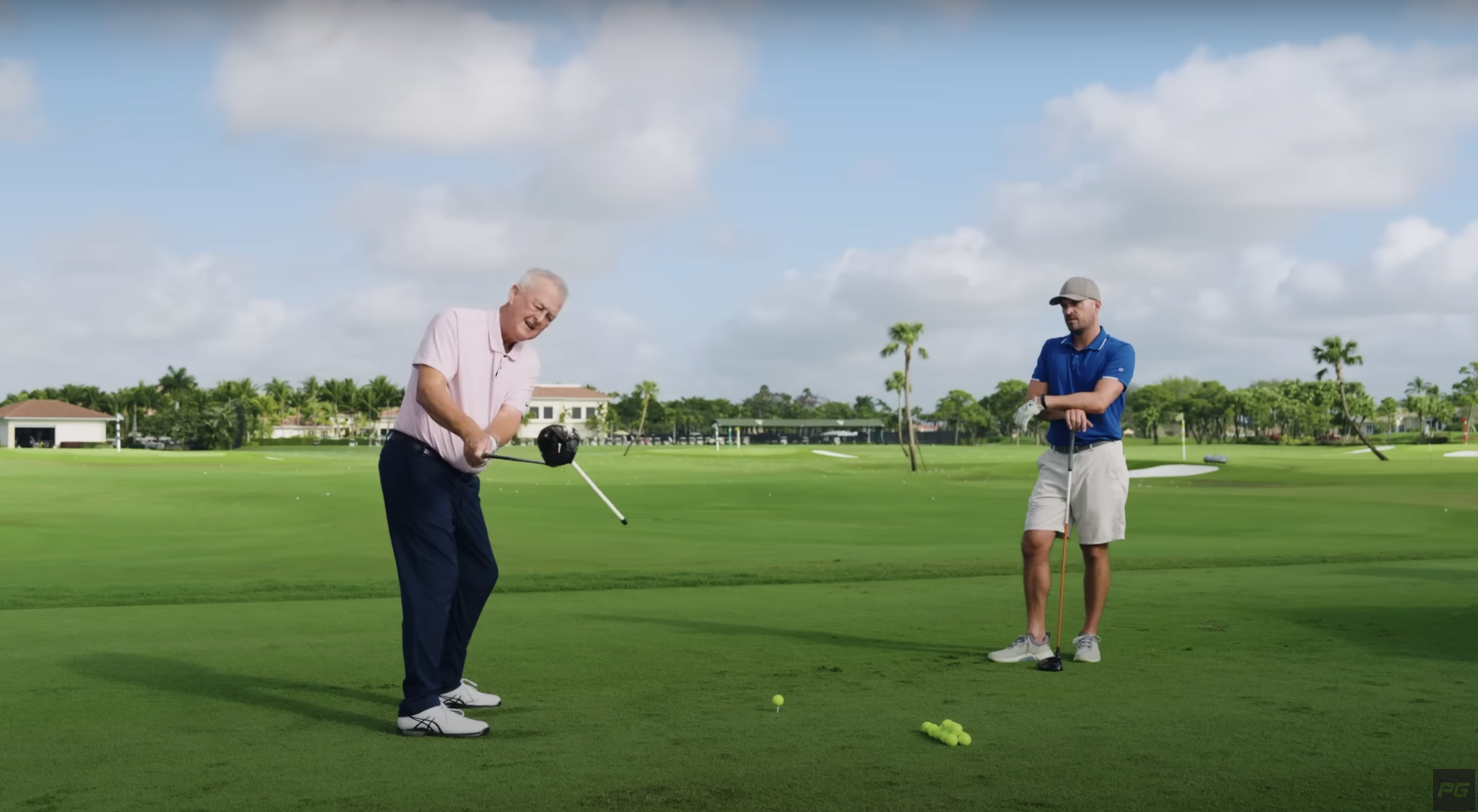 Golf coach Martin Hall demonstrating a takeaway drill with a lie tool taped to the clubface of a driver.