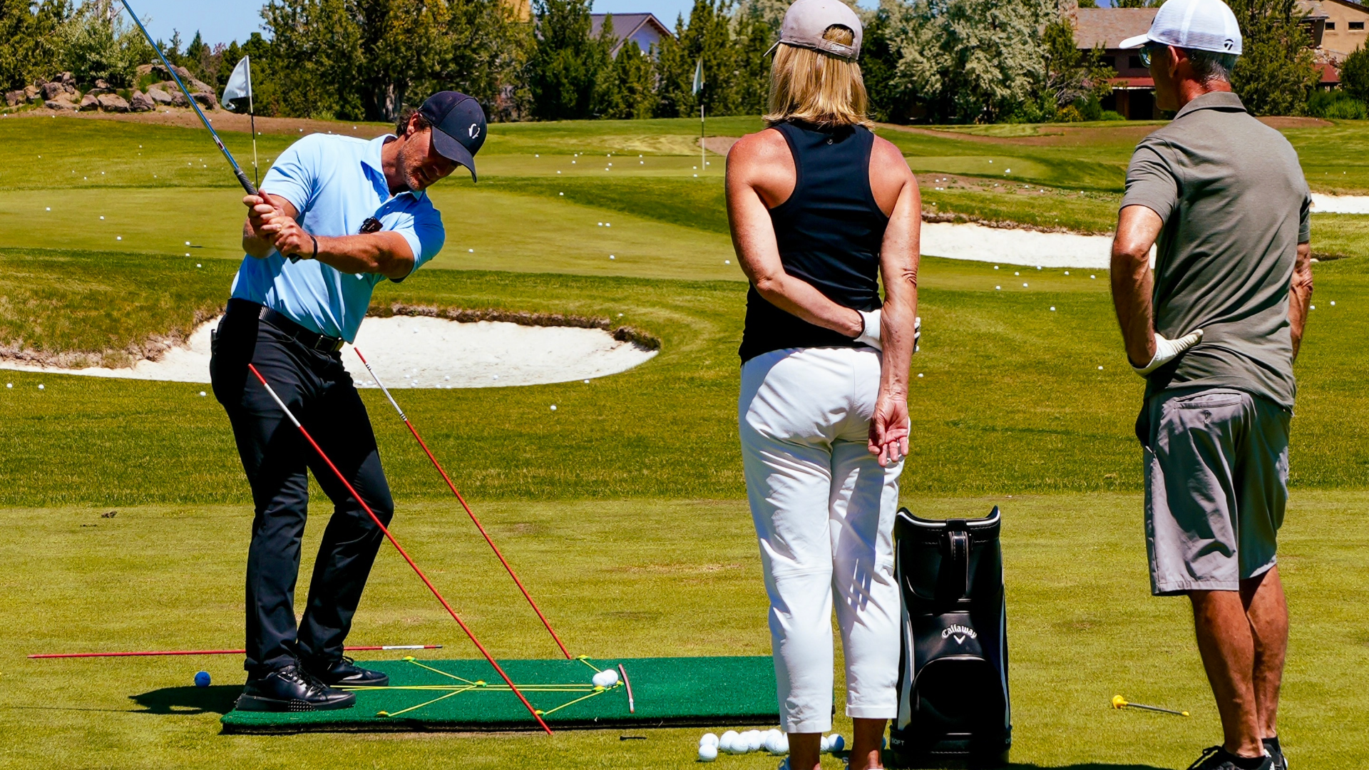 Performance Golf coach Jeff Ritter instructing two golf students on the golf course.