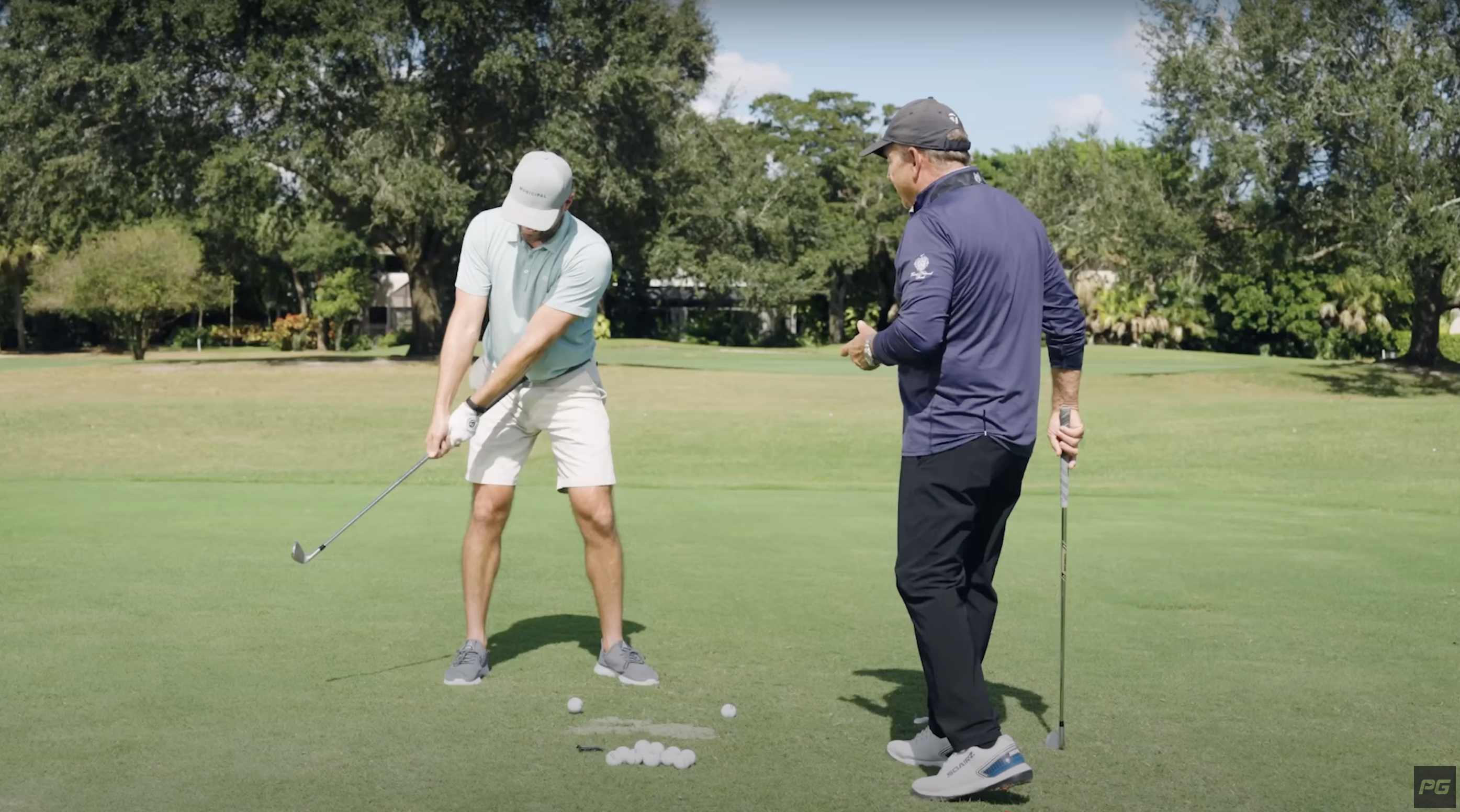 Performance golf coaches Eric Cogorno and Rick Smith demonstrate the Y to Y drill with a golf club.