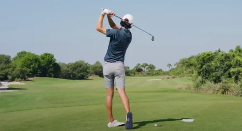 Grant Horvat demonstrates a proper golf swing on the course.