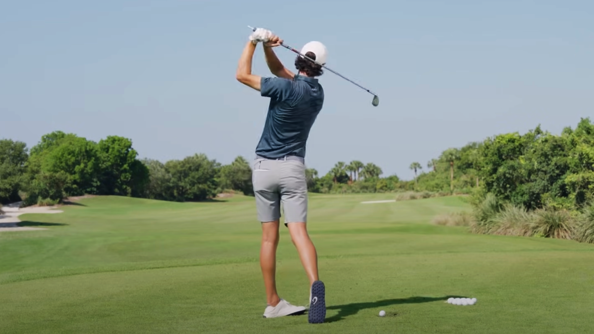 Grant Horvat demonstrates a proper golf swing on the course.