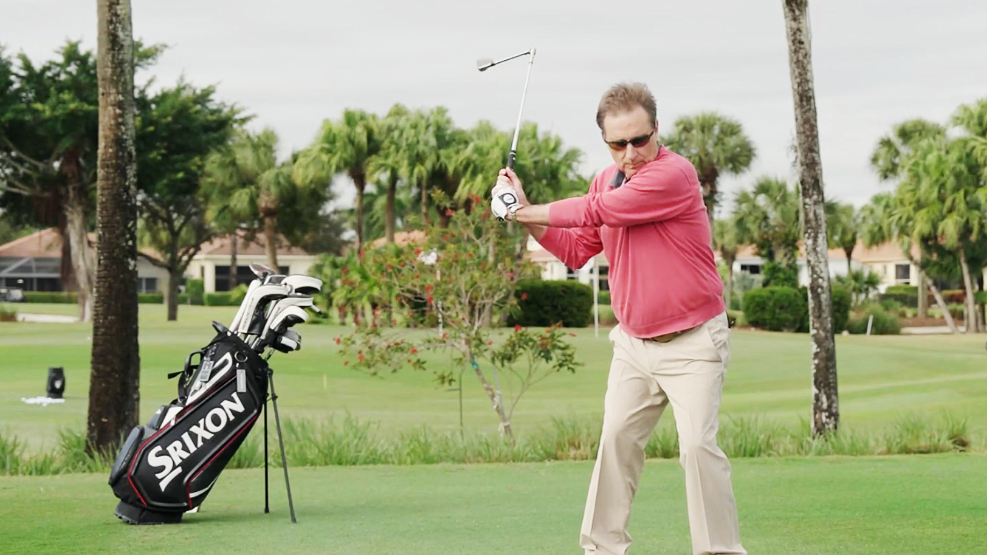 A high handicap golfer using The Hinge training aid, receiving physical feedback on their open clubface in the golf swing.