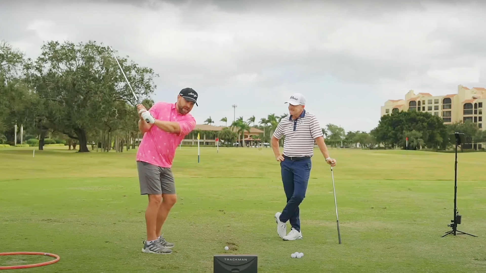 Golf coach Cameron McCormick giving a live lesson to a beginner golfer.