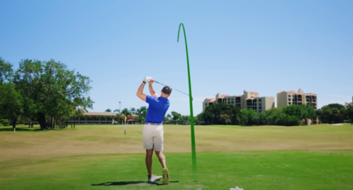 Performance Golf coach showcasing a straight, long golf swing on the course.