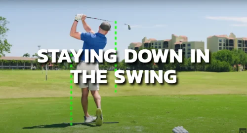 ALT TEXT: Golf coach showing the proper setup and golf swing stance to stay down in the golf swing for more consistent hits.