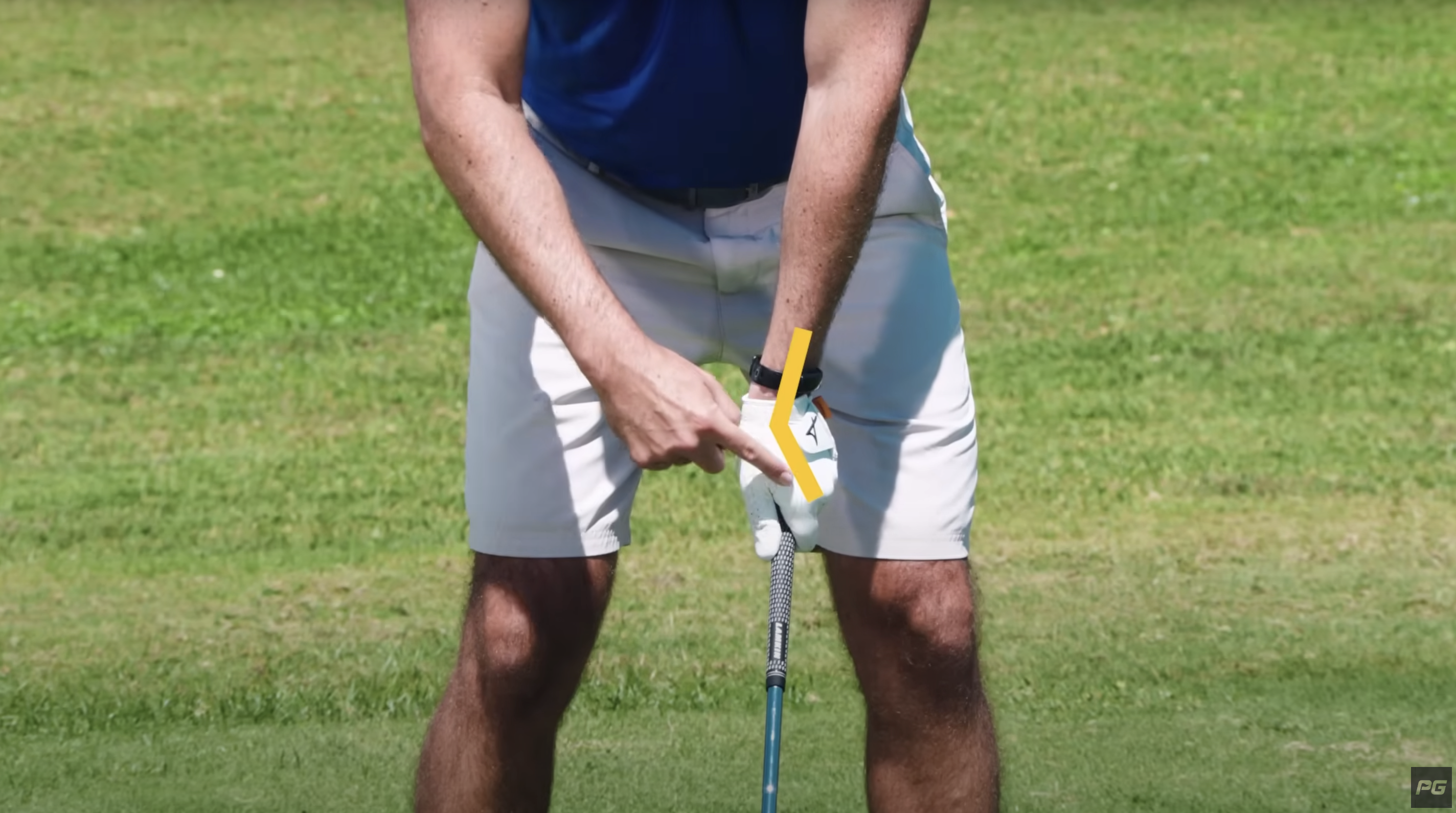 Performance Golf coach pointing to the proper wrist hinge and grip on the golf club.