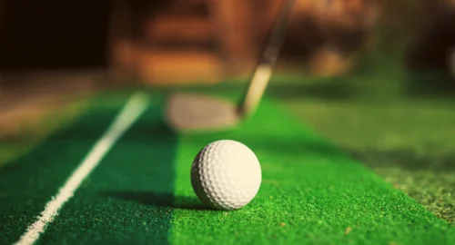 Up close of a golf ball on a golf practice turf.