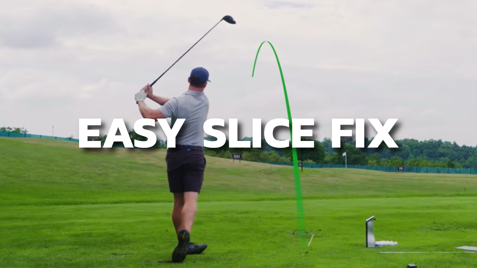 A golfer on the golf course hitting a straight golf ball draw, shown with a green ball path marker.