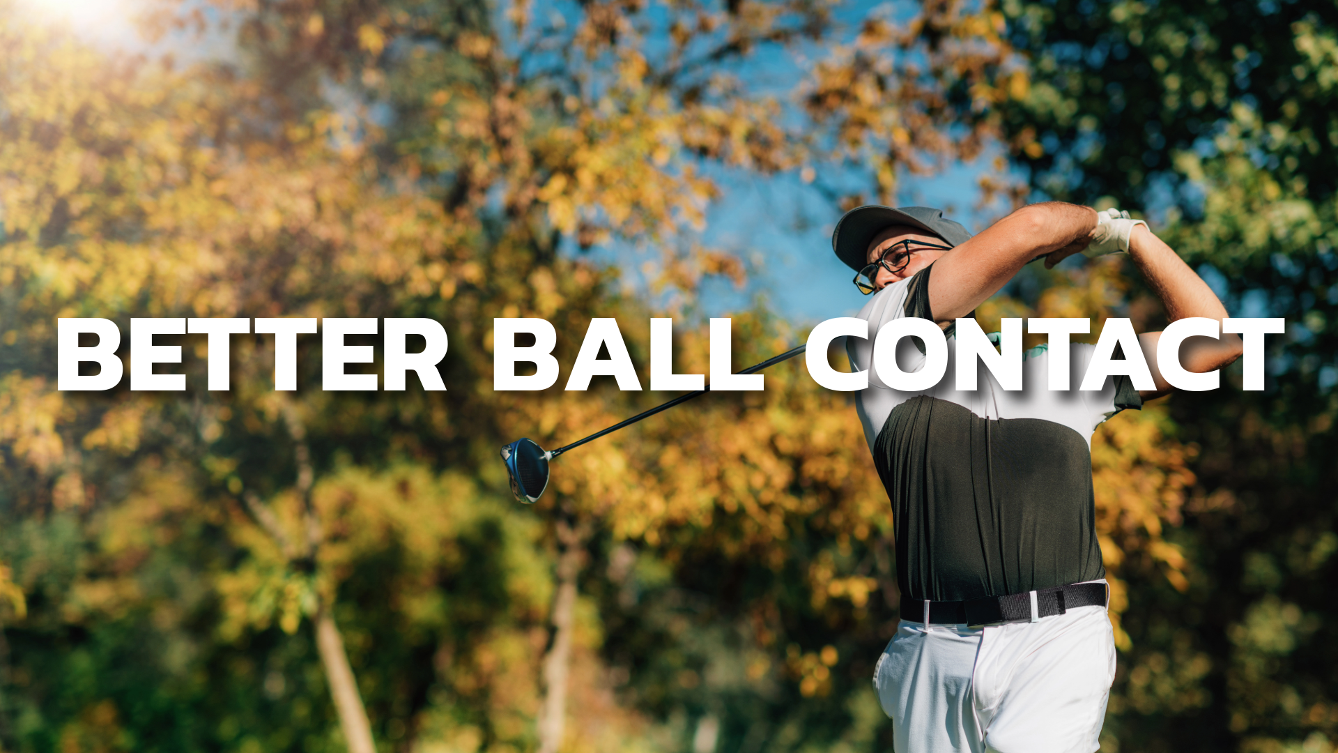 A golfer in fall foliage in the golf swing after hitting the ball.